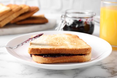 Tasty sandwich with raspberry jam for breakfast on marble table Image of Tasty sandwich with raspberry jam for breakfast on marble table