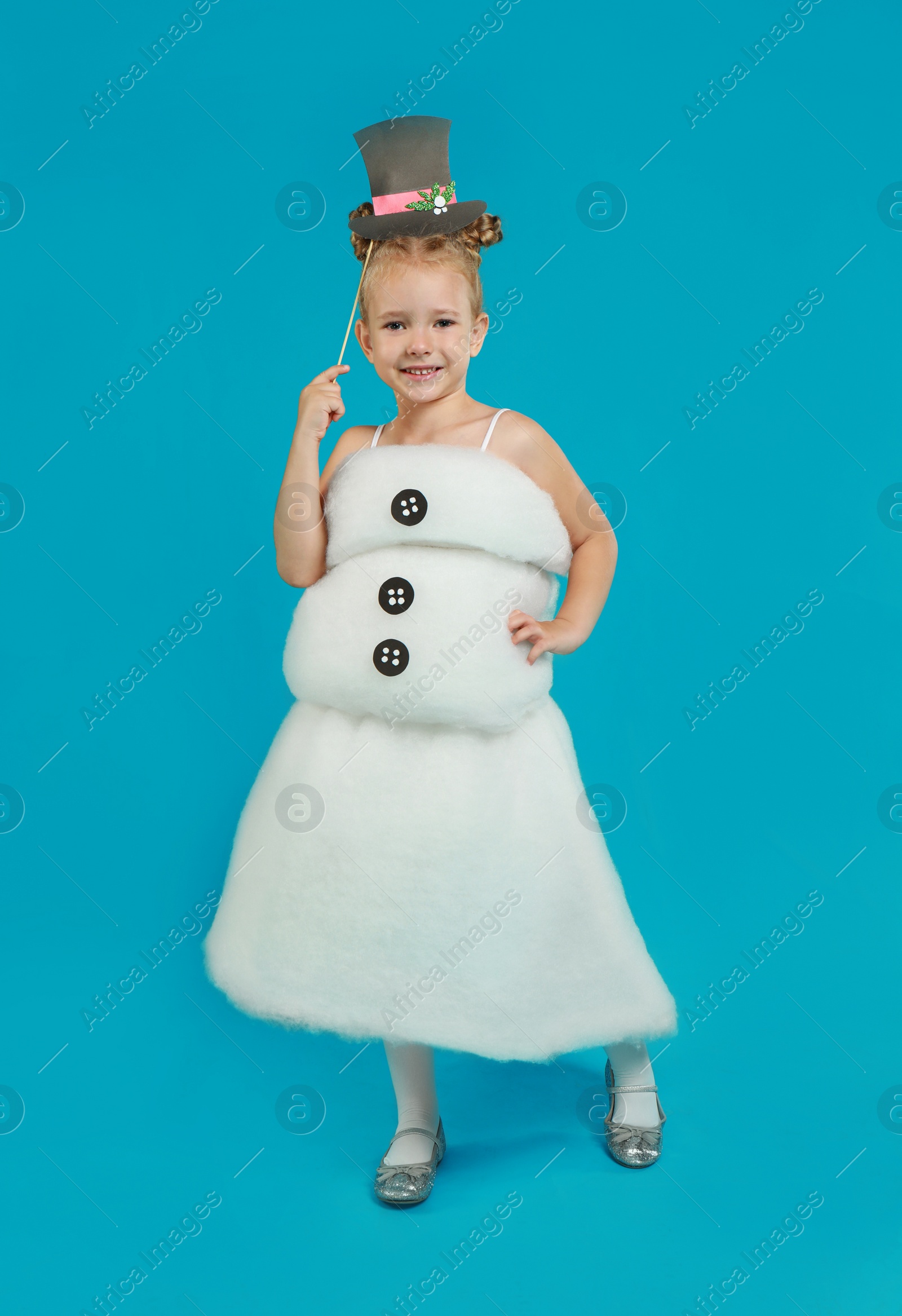 Cute little girl dressed as snowman on light blue background. Christmas suit Image of Cute little girl dressed as snowman on light blue background. Christmas suit