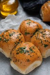 Traditional pampushka buns with garlic and herbs on table, closeup Photo of Traditional pampushka buns with garlic and herbs on table, closeup