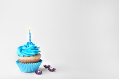 Birthday cupcake with candle on white background Photo of Birthday cupcake with candle on white background