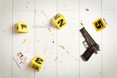 Flat lay composition with evidences on white wooden background. Crime scene Photo of Flat lay composition with evidences on white wooden background. Crime scene