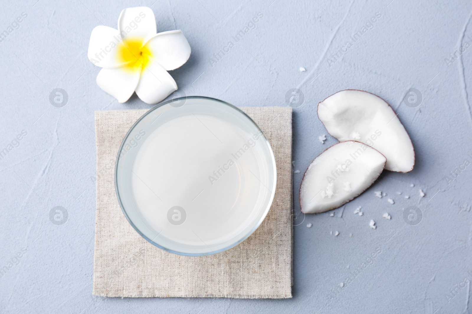 Glass of coconut water on grey background Photo of Glass of coconut water on grey background
