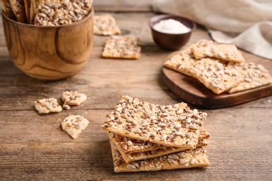 Stack of delicious crackers on wooden table Photo of Stack of delicious crackers on wooden table