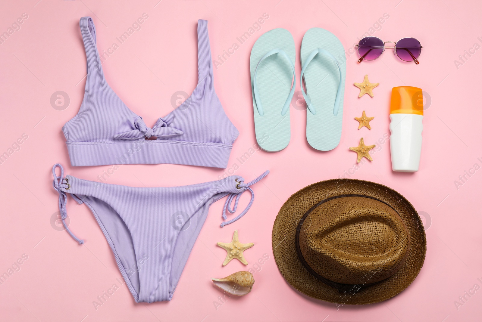 Photo of Flat lay composition with beach objects on pink background