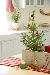 Small Christmas trees and festive decor in kitchen Photo of Small Christmas trees and festive decor in kitchen