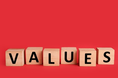 Wooden cubes with word VALUES on red background Photo of Wooden cubes with word VALUES on red background