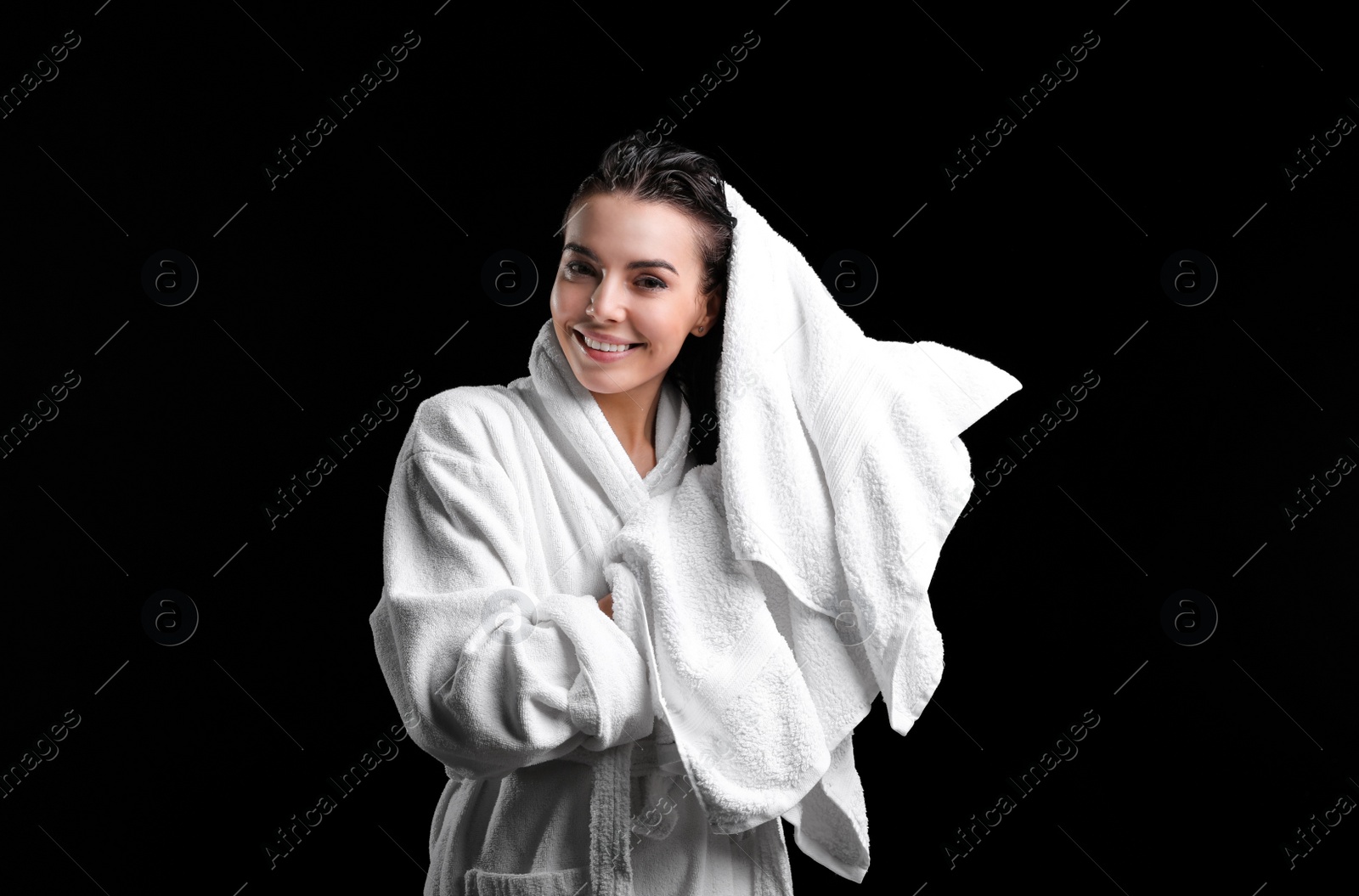 Pretty woman drying hair with towel after washing on black background Photo of Pretty woman drying hair with towel after washing on black background
