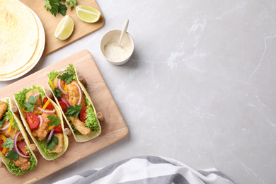 Yummy fish tacos served on marble table, flat lay. Space for text Photo of Yummy fish tacos served on marble table, flat lay. Space for text