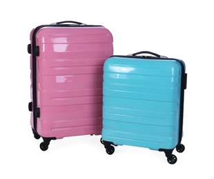 Photo of Stylish suitcases packed for travel on white background. Summer vacation