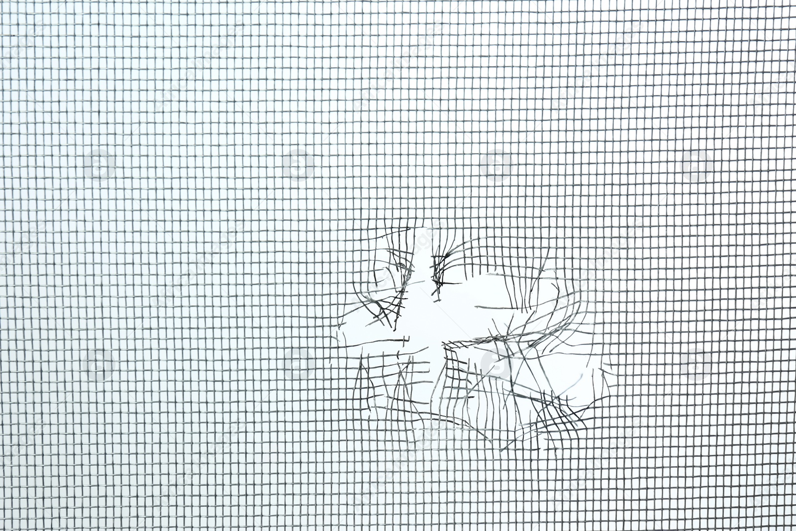 Torn window screen against white background, closeup Photo of Torn window screen against white background, closeup
