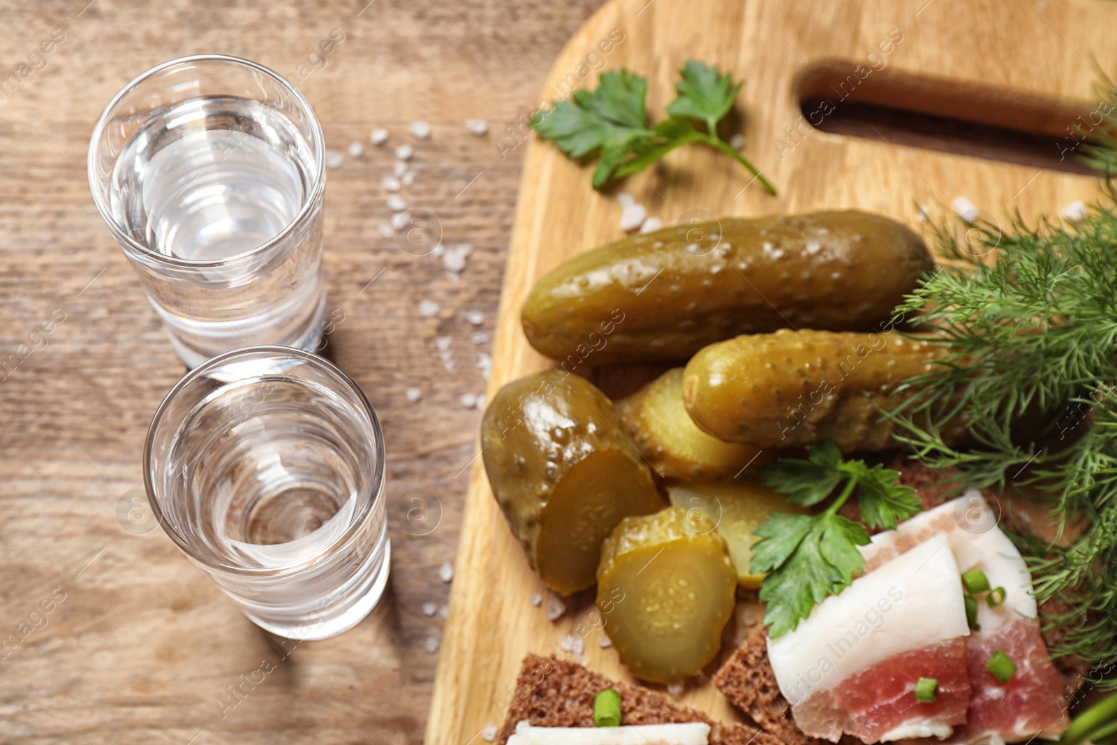 Cold Russian vodka with snacks on wooden table, above view Photo of Cold Russian vodka with snacks on wooden table, above view