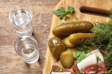 Cold Russian vodka with snacks on wooden table, above view Photo of Cold Russian vodka with snacks on wooden table, above view