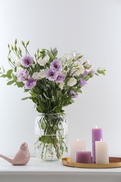 Bouquet of beautiful Eustoma flowers on white table Photo of Bouquet of beautiful Eustoma flowers on white table