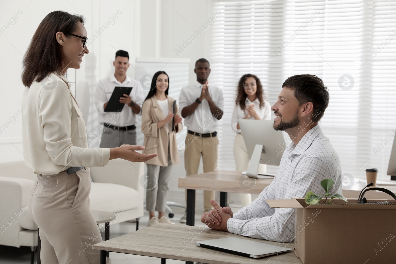 Boss introducing new employee to coworkers in office Photo of Boss introducing new employee to coworkers in office