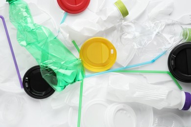 Pile of different plastic items as background, top view Photo of Pile of different plastic items as background, top view