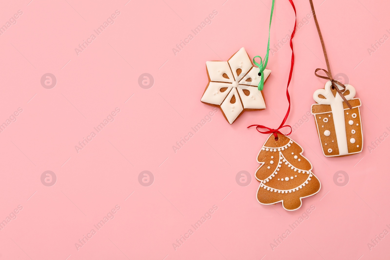 Different delicious Christmas cookies on pink background, flat lay. Space for text Photo of Different delicious Christmas cookies on pink background, flat lay. Space for text