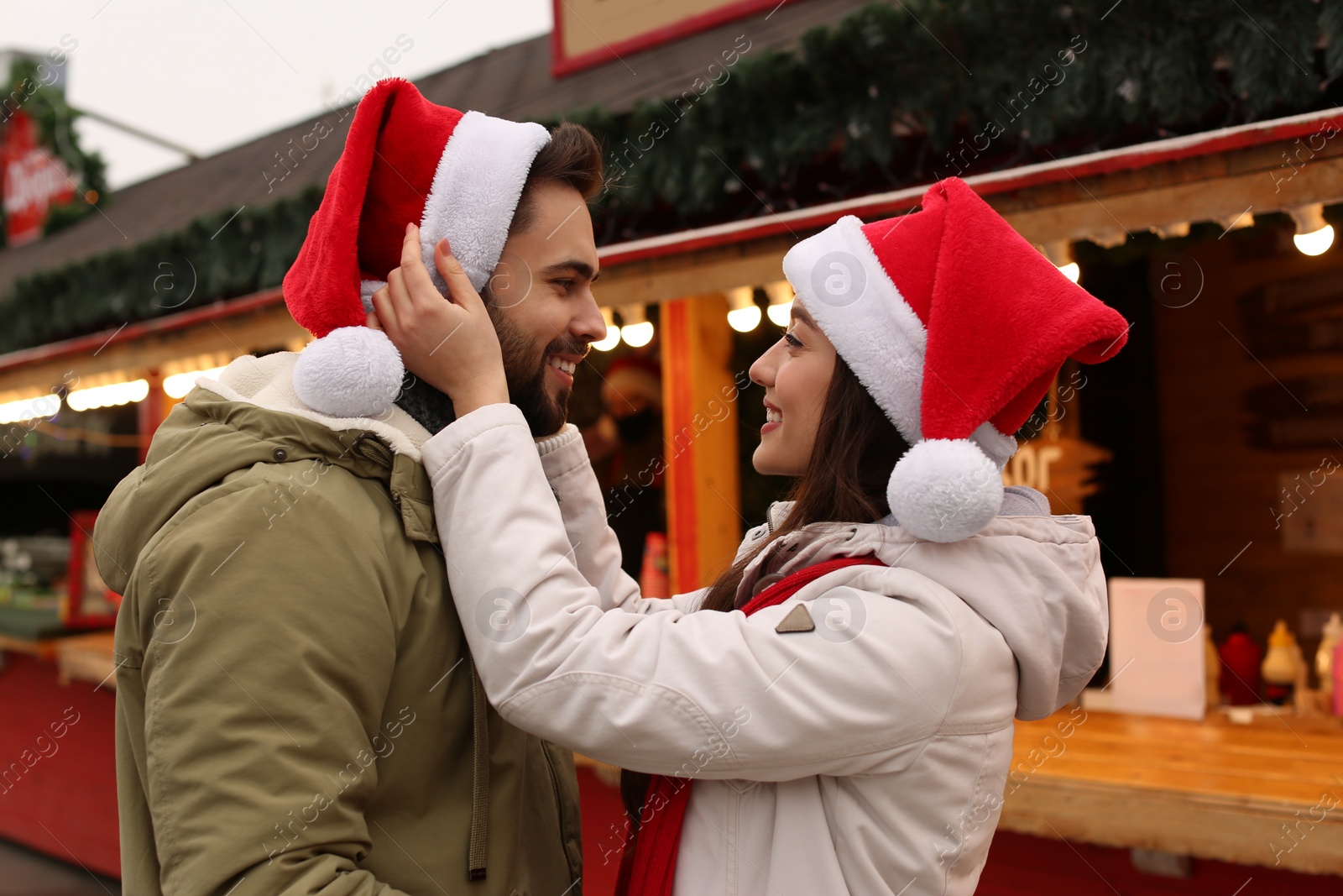 Lovely couple spending time together at Christmas fair Photo of Lovely couple spending time together at Christmas fair
