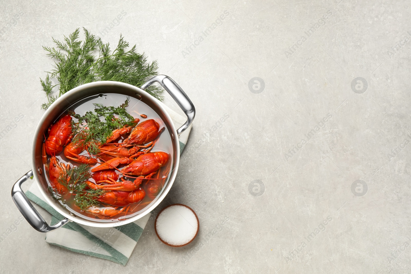 Fresh delicious crayfishes in pot on light grey table, flat lay. Space for text Photo of Fresh delicious crayfishes in pot on light grey table, flat lay. Space for text
