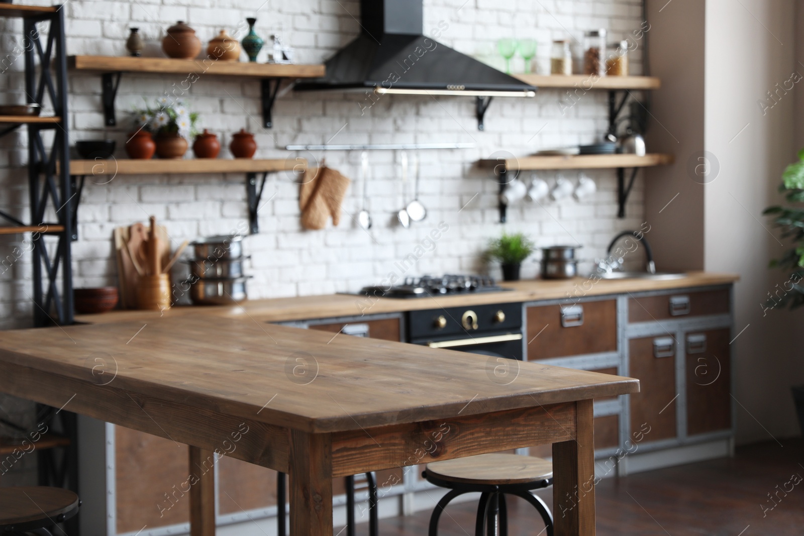 Photo of Empty wooden table in beautiful kitchen. Interior design