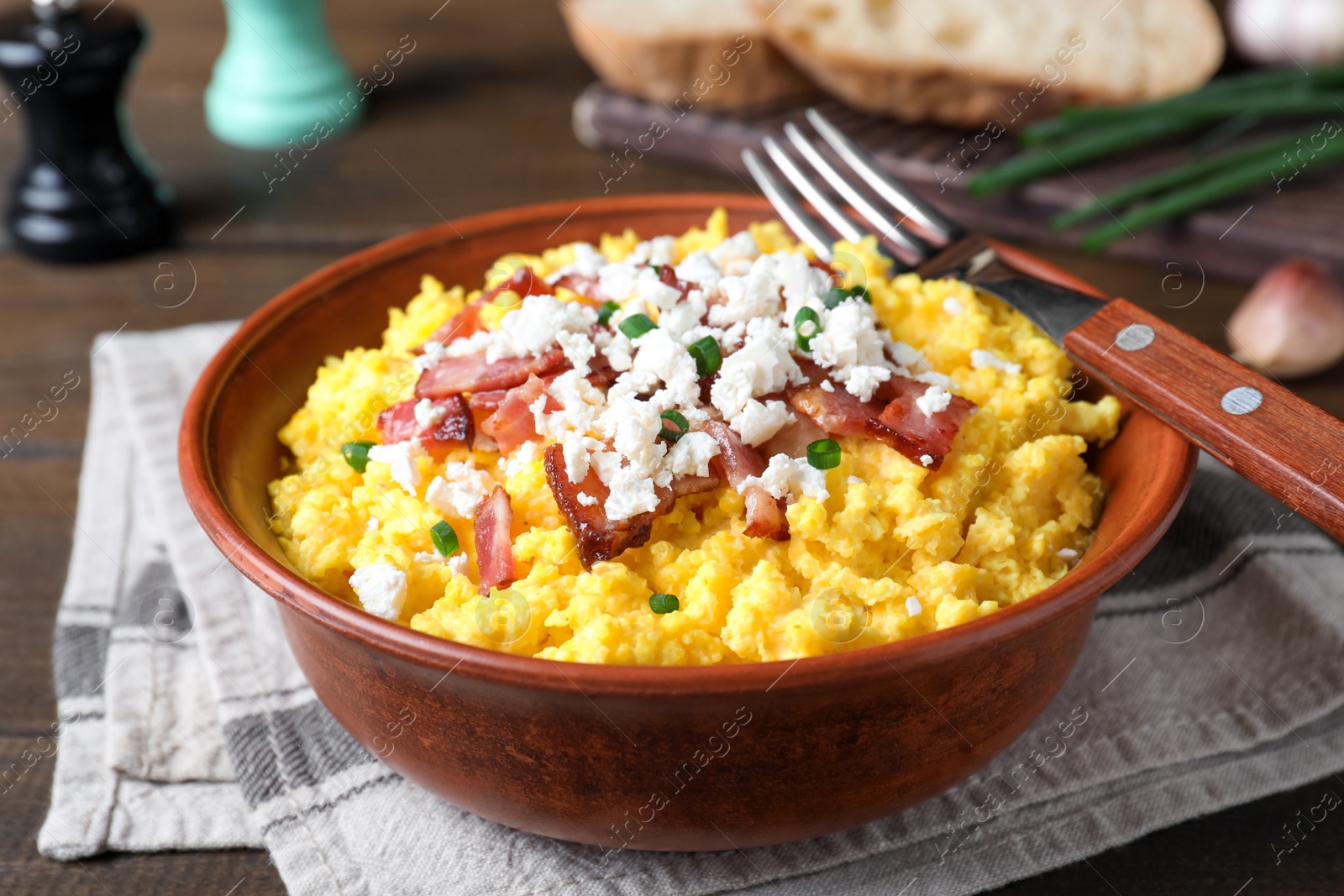 Tasty banosh served with brynza and pork cracklings in bowl on table, closeup. Traditional Ukrainian dish Photo of Tasty banosh served with brynza and pork cracklings in bowl on table, closeup. Traditional Ukrainian dish
