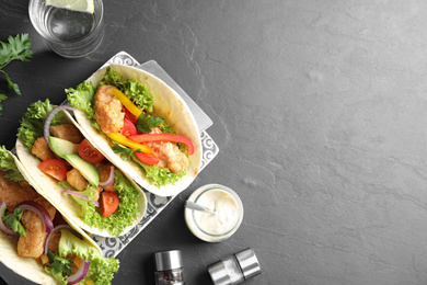 Photo of Delicious fish tacos served on grey table, flat lay with space for text