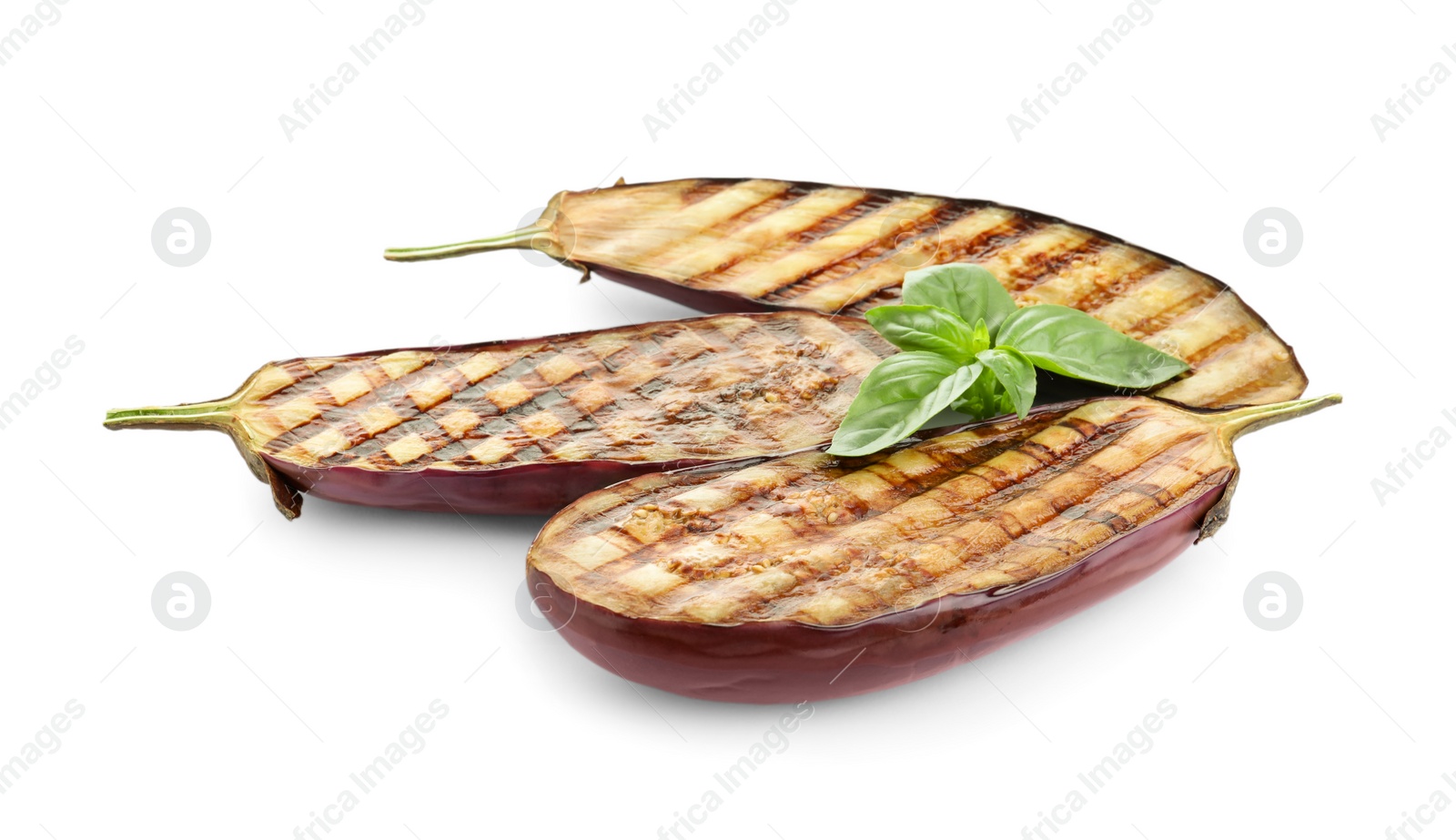 Delicious grilled eggplant halves and basil on white background Photo of Delicious grilled eggplant halves and basil on white background