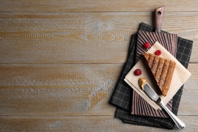 Tasty sandwich with raspberry jam and peanut butter for breakfast on wooden table, flat lay. Space for text Image of Tasty sandwich with raspberry jam and peanut butter for breakfast on wooden table, flat lay. Space for text