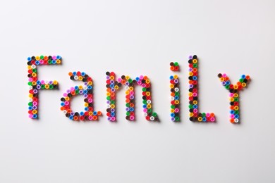 Word Family made of melty beads on white background, flat lay Photo of Word Family made of melty beads on white background, flat lay