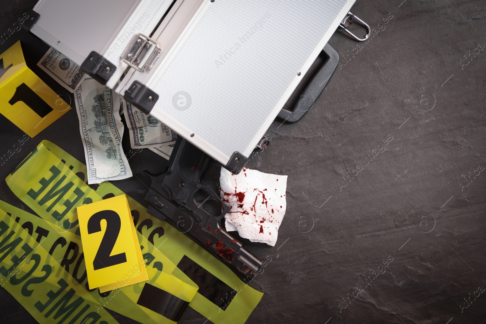 Flat lay composition with evidences and crime scene markers on black background Photo of Flat lay composition with evidences and crime scene markers on black background