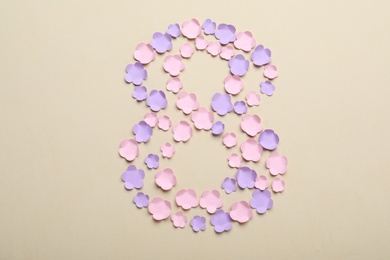 Number 8 made with paper flowers on beige background, flat lay. International Women's day Photo of Number 8 made with paper flowers on beige background, flat lay. International Women's day