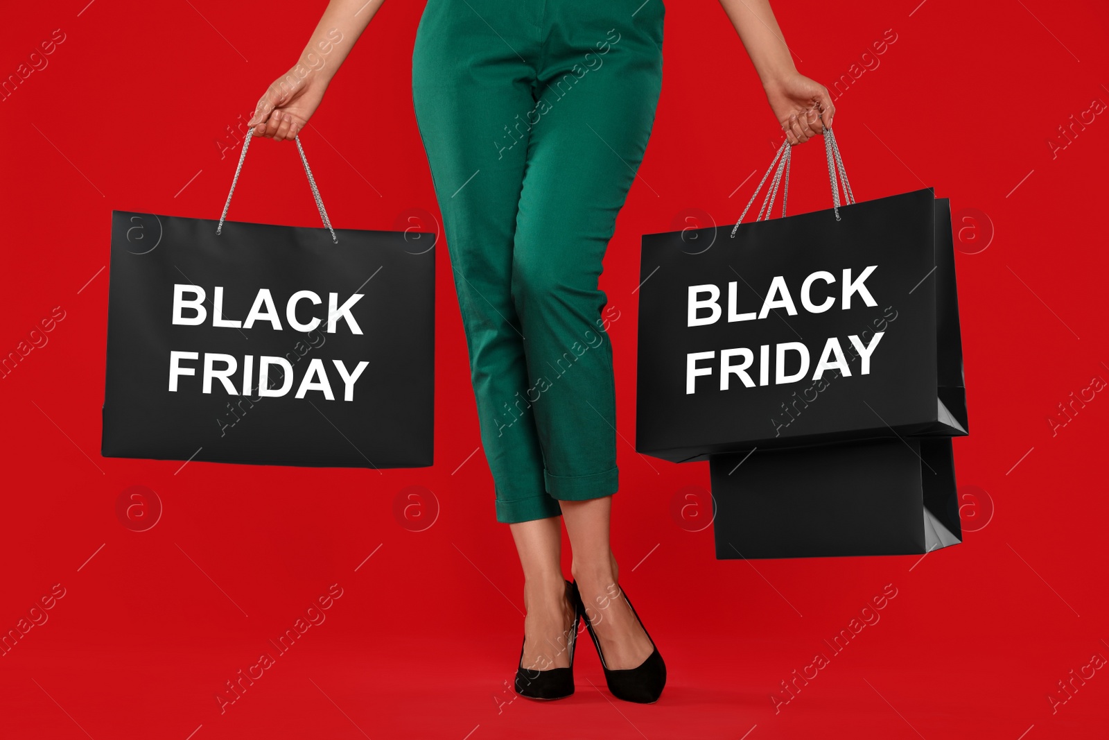 Woman with shopping bags on red background, closeup. Black Friday Photo of Woman with shopping bags on red background, closeup. Black Friday