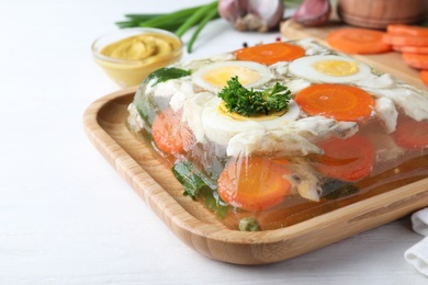 Delicious fish aspic served on white wooden table, closeup Photo of Delicious fish aspic served on white wooden table, closeup