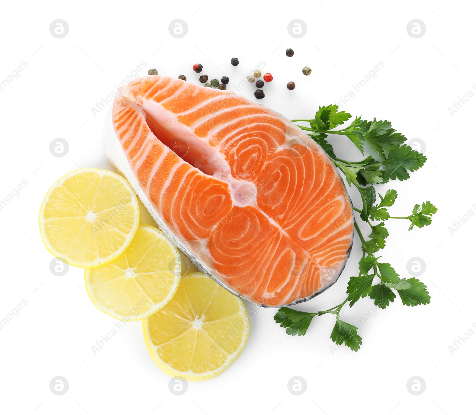 Fresh raw salmon with pepper, lemon and parsley on white background, top view. Fish delicacy Photo of Fresh raw salmon with pepper, lemon and parsley on white background, top view. Fish delicacy