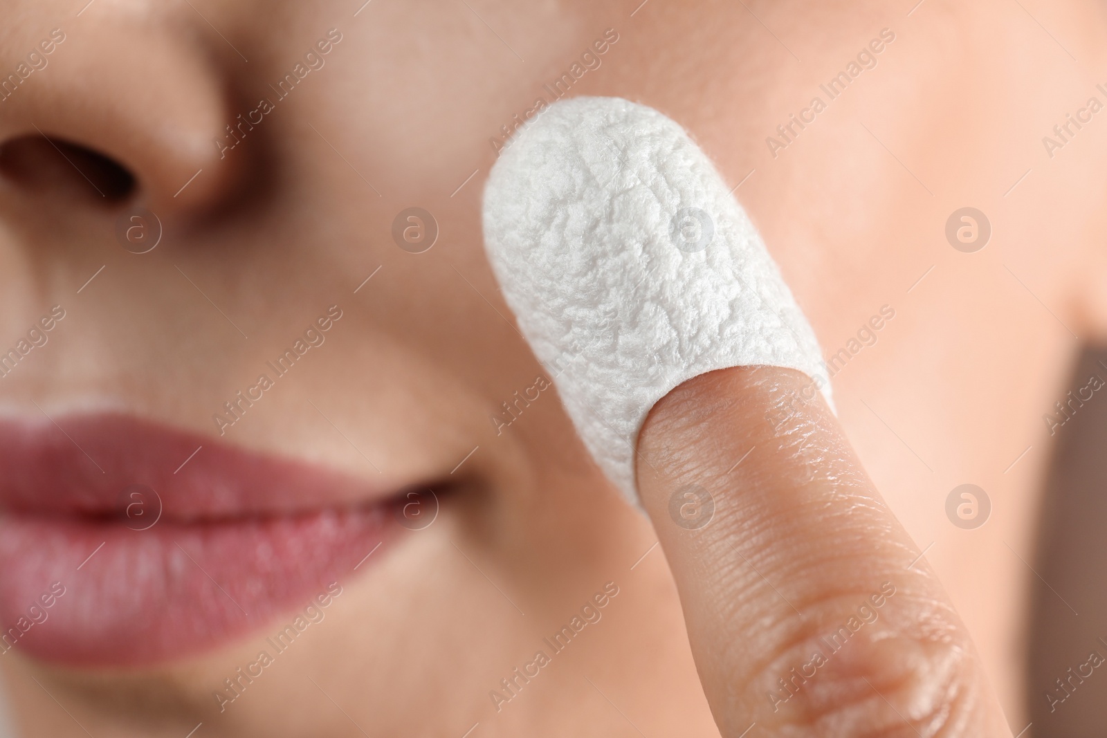 Woman using silkworm cocoon in skin care routine, closeup Photo of Woman using silkworm cocoon in skin care routine, closeup