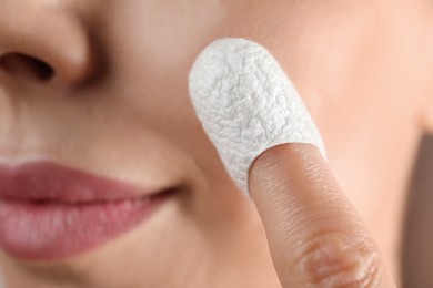Woman using silkworm cocoon in skin care routine, closeup Photo of Woman using silkworm cocoon in skin care routine, closeup