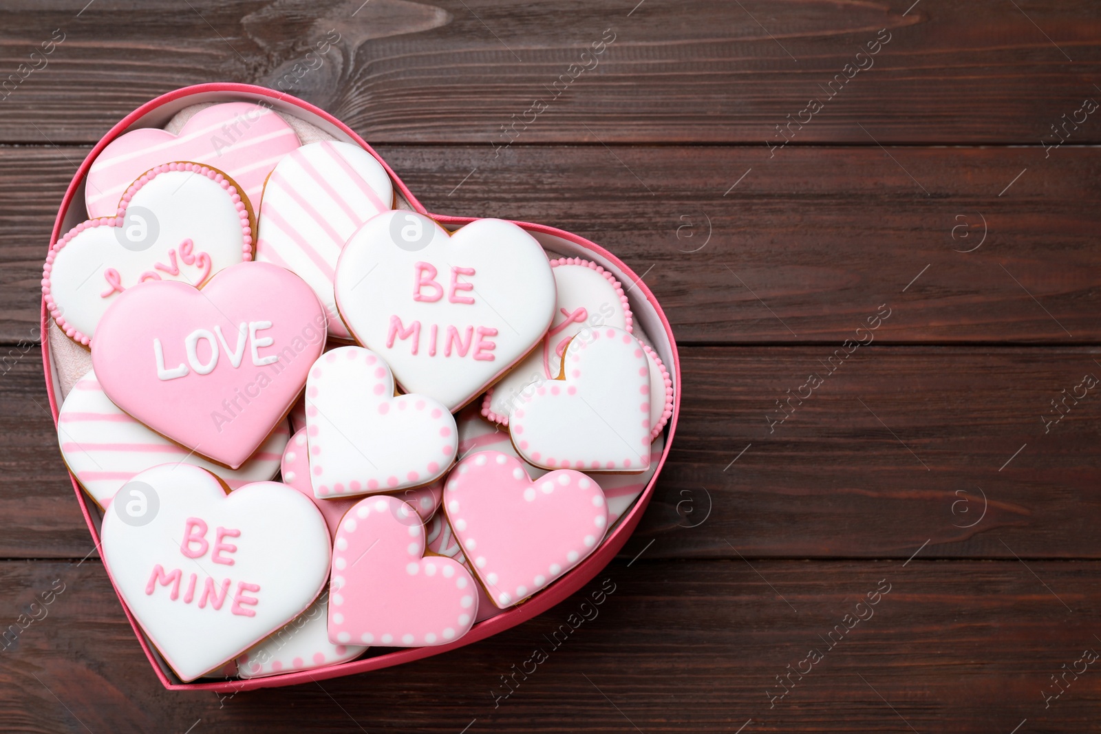 Valentine's day cookies in heart shaped box on wooden table, top view. Space for text Photo of Valentine's day cookies in heart shaped box on wooden table, top view. Space for text