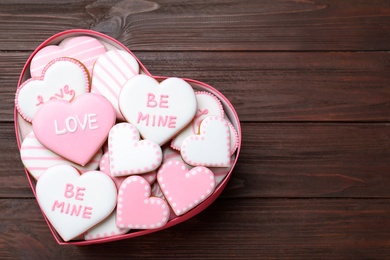 Valentine's day cookies in heart shaped box on wooden table, top view. Space for text Photo of Valentine's day cookies in heart shaped box on wooden table, top view. Space for text