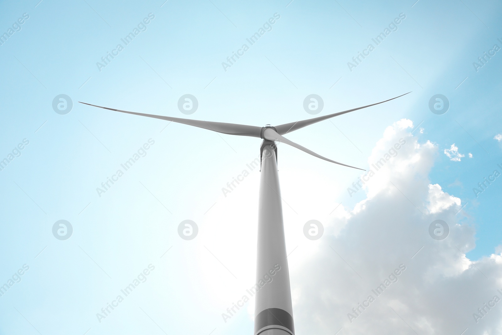 Modern wind turbine against blue sky, low angle view. Energy efficiency Photo of Modern wind turbine against blue sky, low angle view. Energy efficiency
