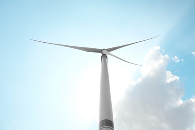 Modern wind turbine against blue sky, low angle view. Energy efficiency Photo of Modern wind turbine against blue sky, low angle view. Energy efficiency