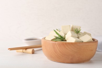 Delicious tofu with rosemary served on white wooden table. Space for text Photo of Delicious tofu with rosemary served on white wooden table. Space for text