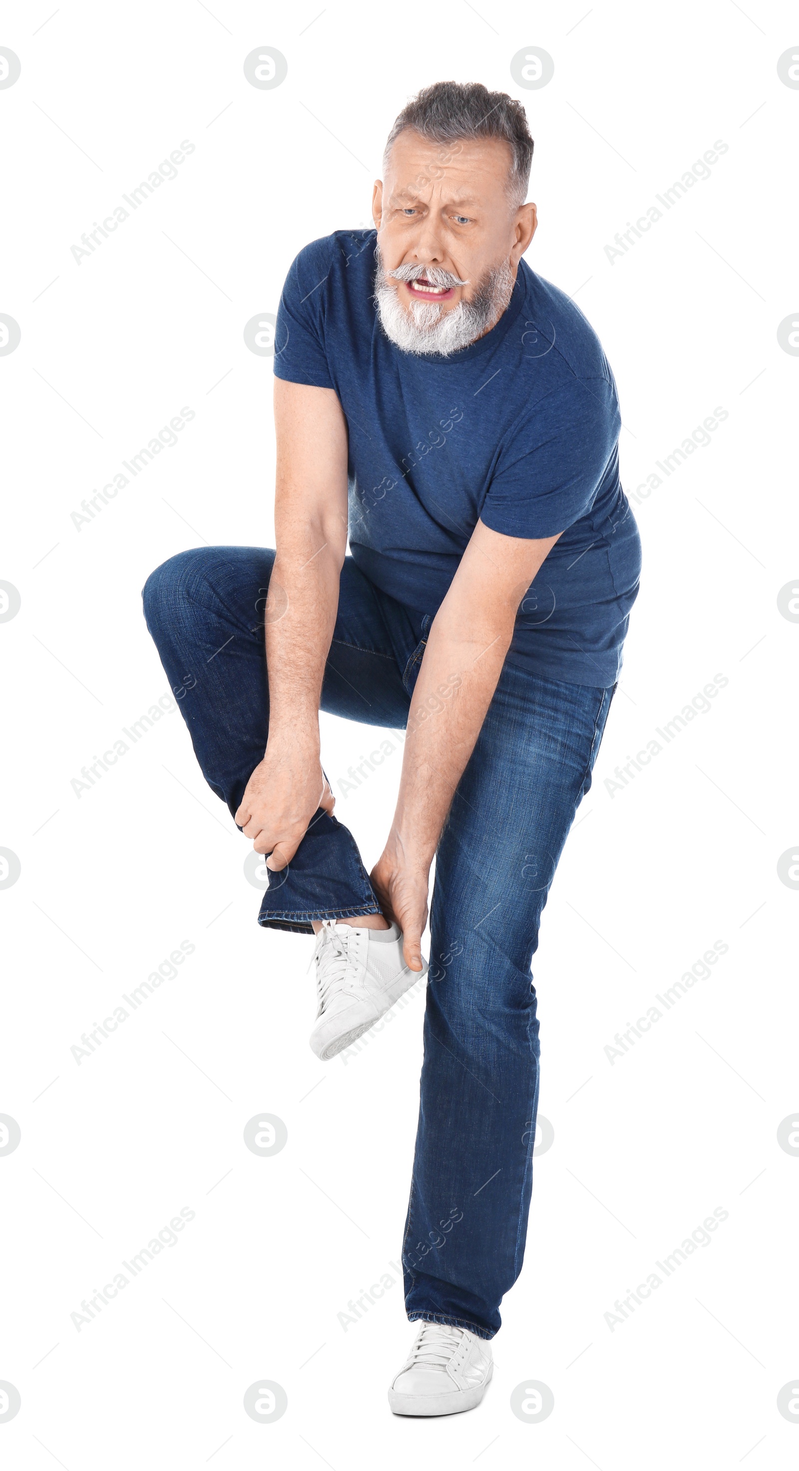 Man suffering from leg pain on white background Photo of Man suffering from leg pain on white background