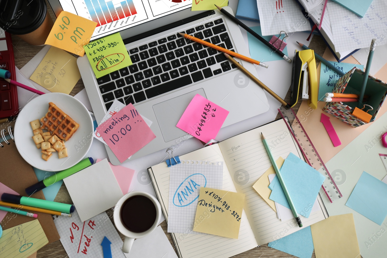 Laptop, notes and office stationery in mess on desk, top view. Overwhelmed with work Photo of Laptop, notes and office stationery in mess on desk, top view. Overwhelmed with work