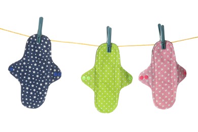 Many different cloth menstrual pads hanging isolated on white Photo of Many different cloth menstrual pads hanging isolated on white