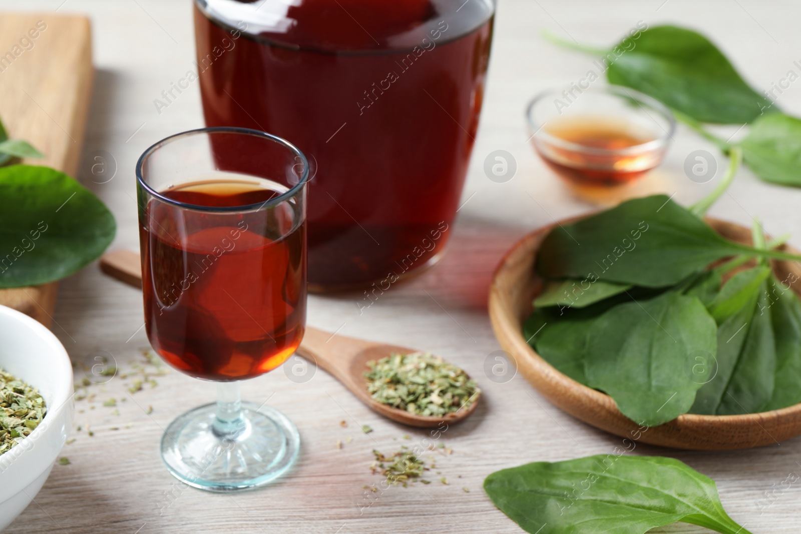 Photo of Broadleaf plantain tincture on white wooden table