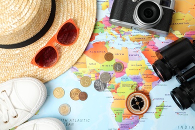 Flat lay composition with different travel accessories on world map. Planning summer vacation trip Photo of Flat lay composition with different travel accessories on world map. Planning summer vacation trip