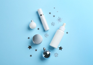 Flat lay composition with different cosmetic products on light blue background. Winter care Photo of Flat lay composition with different cosmetic products on light blue background. Winter care