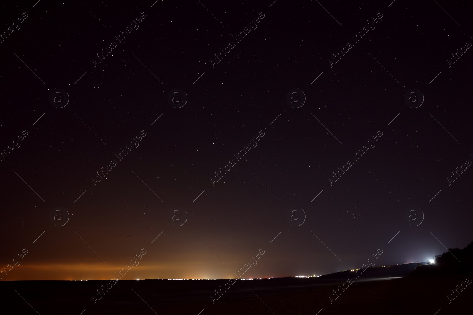 Picturesque view of starry sky at night on seaside Photo of Picturesque view of starry sky at night on seaside