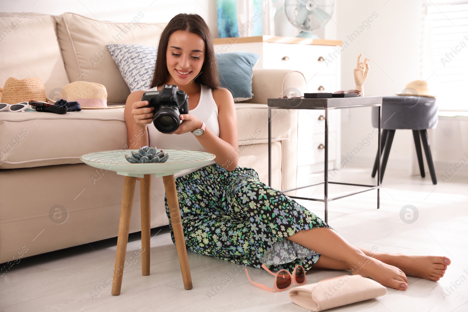 Photo of Young photographer taking picture of jewelry indoors