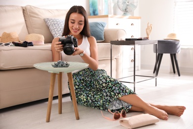 Young photographer taking picture of jewelry indoors Photo of Young photographer taking picture of jewelry indoors