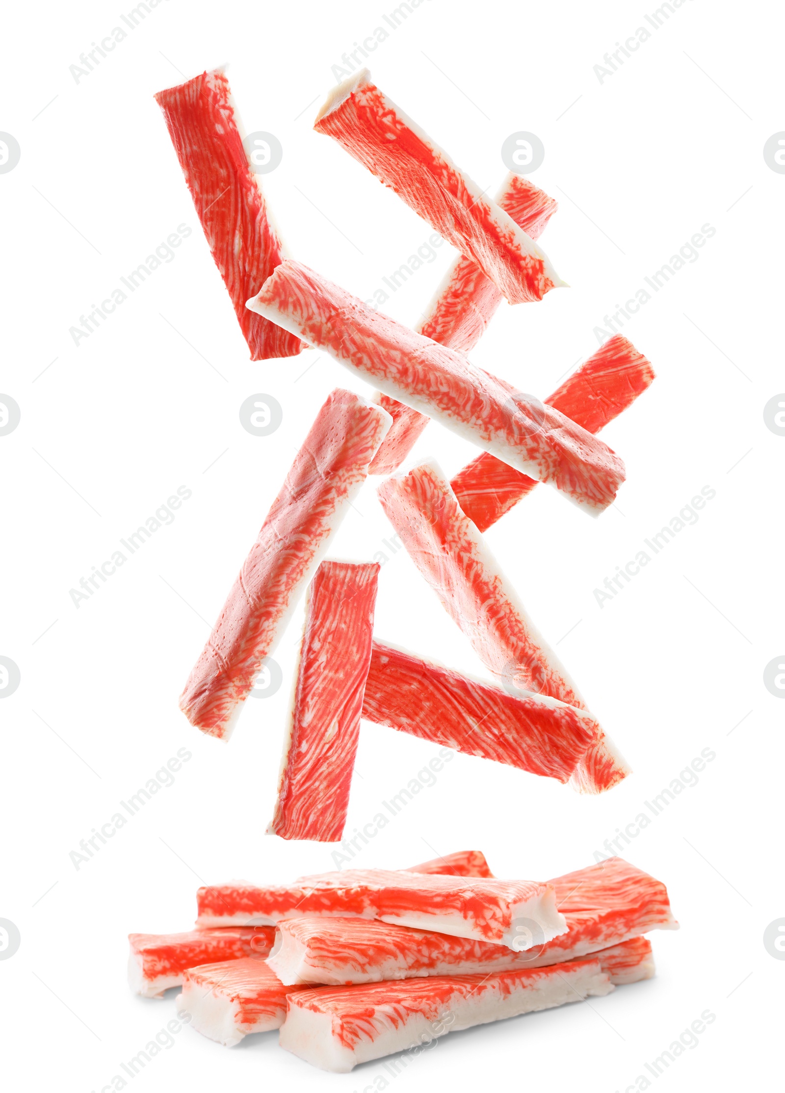 Many fresh crab sticks falling on white background Image of Many fresh crab sticks falling on white background